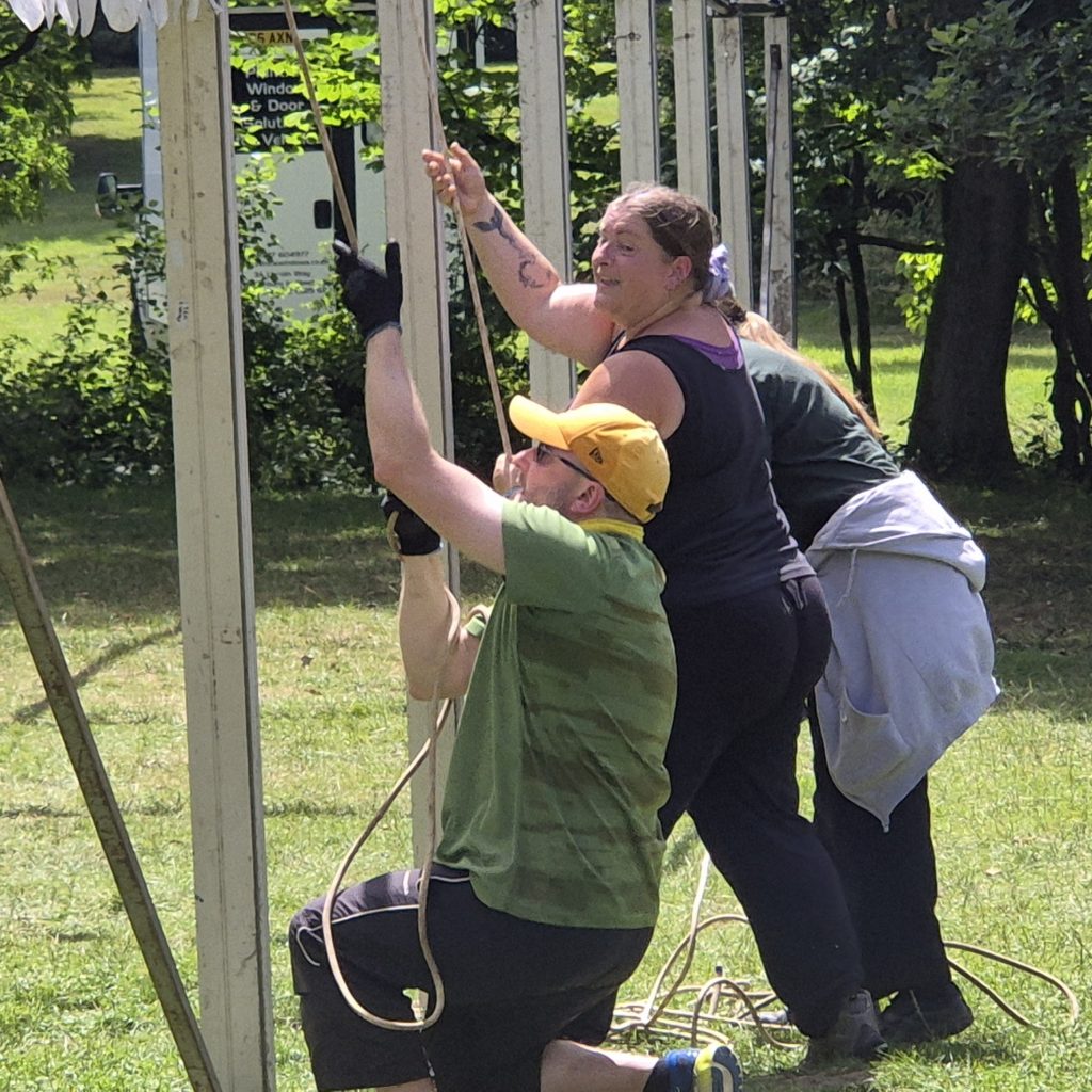 Volunteer parents putting up a large narquee. #DringyGroupCamp25