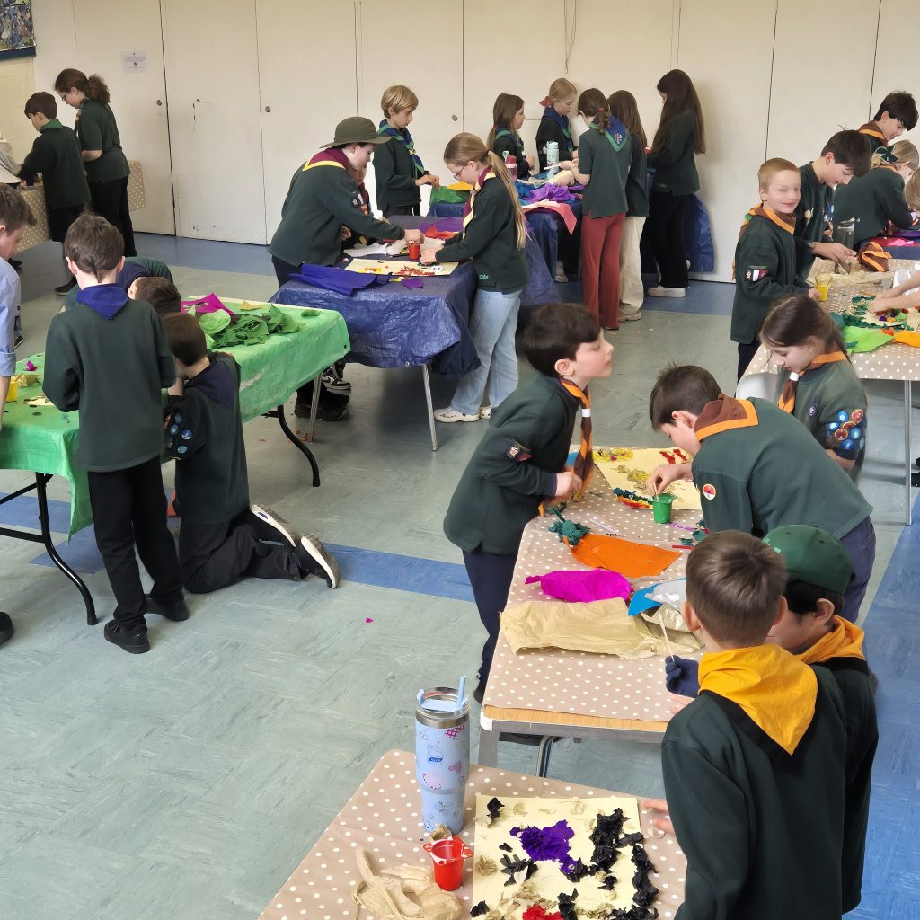 A view of part of the room with Cubs working on creating posters